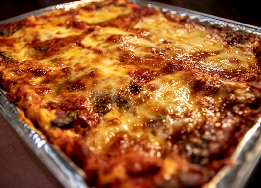 Lasagna (Vegetarian/GF Version available). Small Pan: Feeds about 3 people  Casserole: Have yourself a dinner party  HOMEMADE NOODLES!  Cheesy layers of Homemade Pasta, Organic Tomatoes, Hunter Cattle Pastured Pork and Ground Beef, Organic Spinach, and did we mention CHEESE? So much cheese...