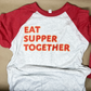 Soft, comfortable red and gray baseball jersey style T shirt with 3/4 length sleeves. Text on front reads "EAT SUPPER TOGETHER"
